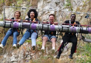 Four people on a high altitude swing