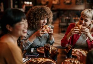 Three Women enjoying a gourmet burger meal