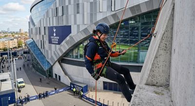 Person abseiling down a stadium wall