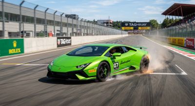 Green Lamborghini driving fast on a track