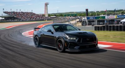 Ford Mustang cruising along a track