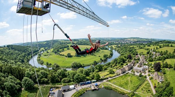 A thrill-seeker freefalling mid-air during an extreme UK bungee jump experience