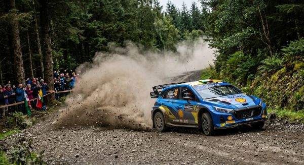 Rally car drifting on gravel