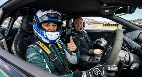 Driver giving a thumbs up in a supercar