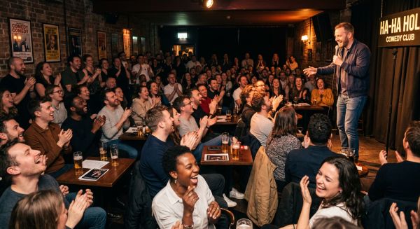 Friends laughing together at a comedy club