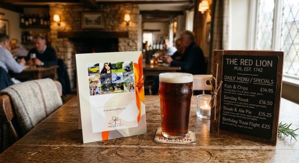 A wrapped gift box next to a pint in a UK pub