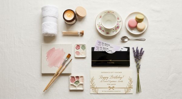 Two women clinking champagne glasses at a luxury afternoon tea