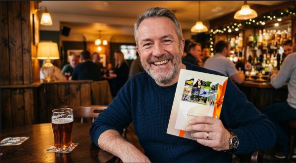 Man holding an experience day voucher envelope