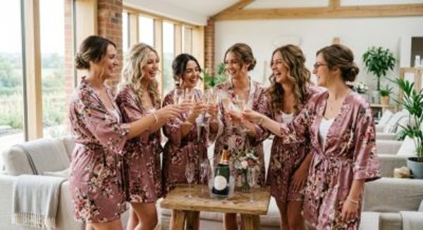 Bridesmaids clinking champagne flutes in a modern UK spa