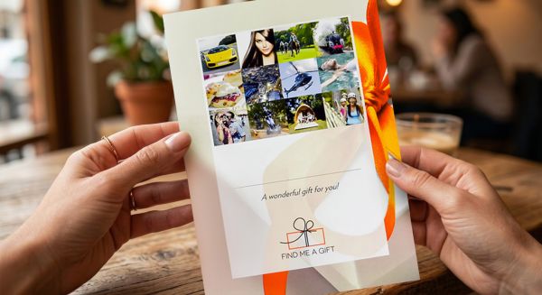 Person holding an experience gift voucher
