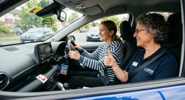 Instructor and teenager during a first time junior car experience
