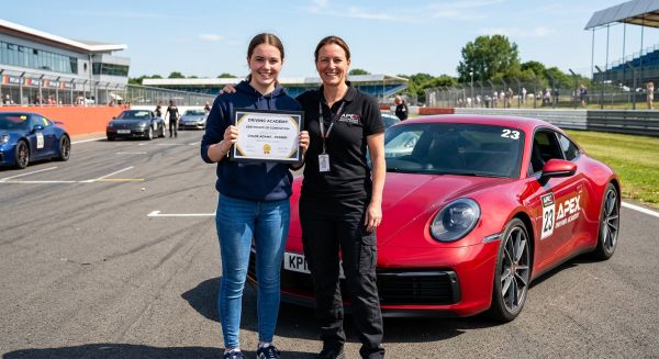 Teenager holding a certificate after completing a junior car experience