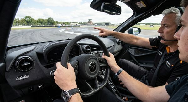 Young driver holding a steering wheel during a junior supercar experience