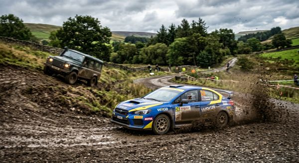A rally car drifting on a dirt track during an off road driving experience day
