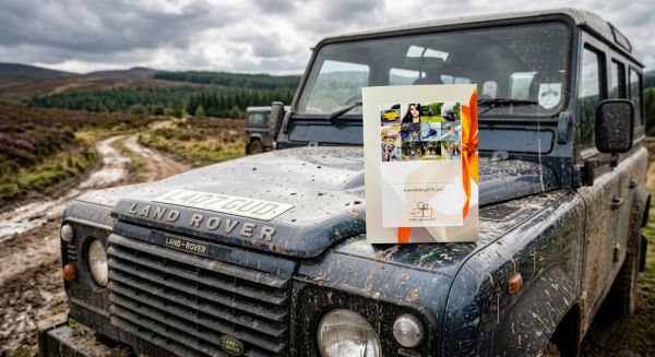 Gift voucher box on the bonnet of a muddy 4x4