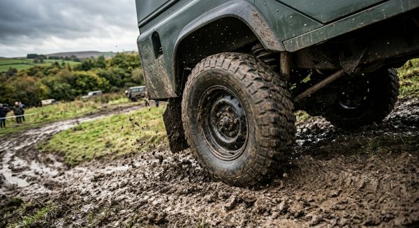 Close up of a 4x4 tyre on a muddy hill