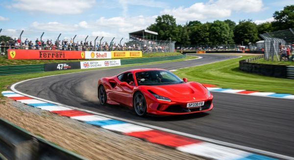 Red supercar speeding on a UK race track