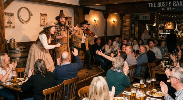 Guests participating in an immersive theatrical cocktail experience