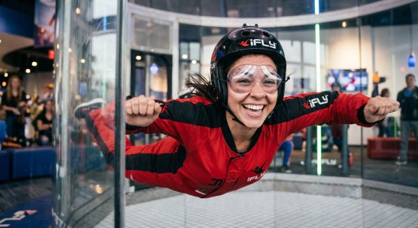 A person smiling while indoor skydiving