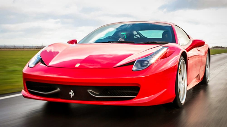 Man driving a Ferrari on a racetrack during the Triple Supercar Drive experience
