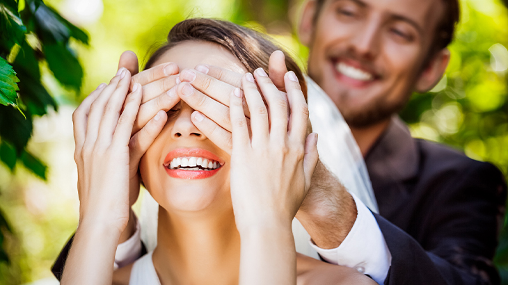 Groom surprising smiling bride on wedding day – joyful newlywed moment perfect for romantic wedding gift experience inspiration