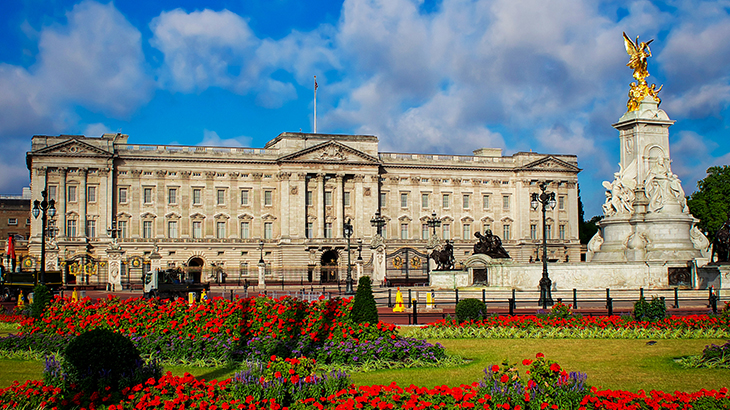 Buckingham Palace with Queen Victoria Memorial and blooming flowers – iconic London landmark and royal experience gift destination