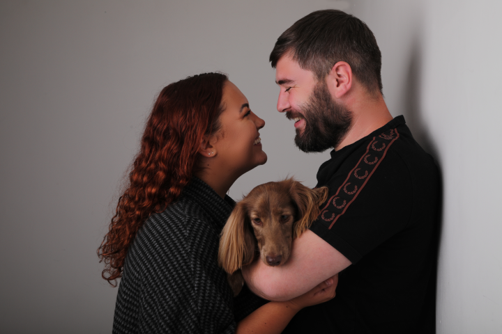Millie and her partner holding her puppy